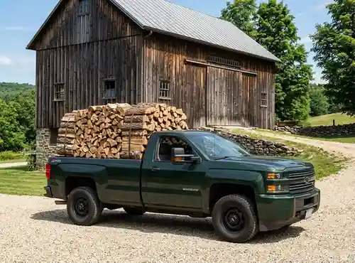 green pickup truck logs delivery