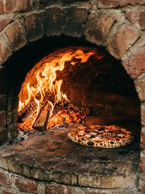 seasonal pizza baking in wood fired oven